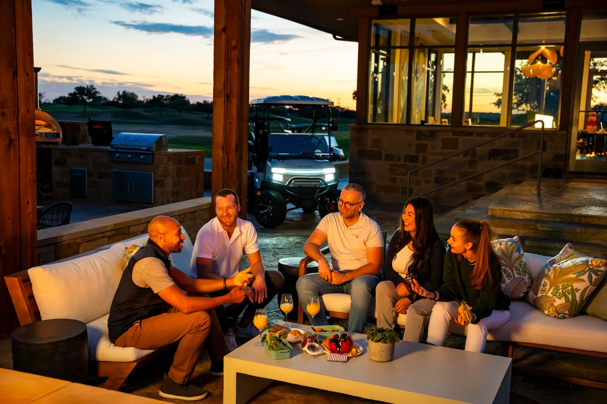 Sunset gathering on a Lake Erie patio with a Denago cart in the background